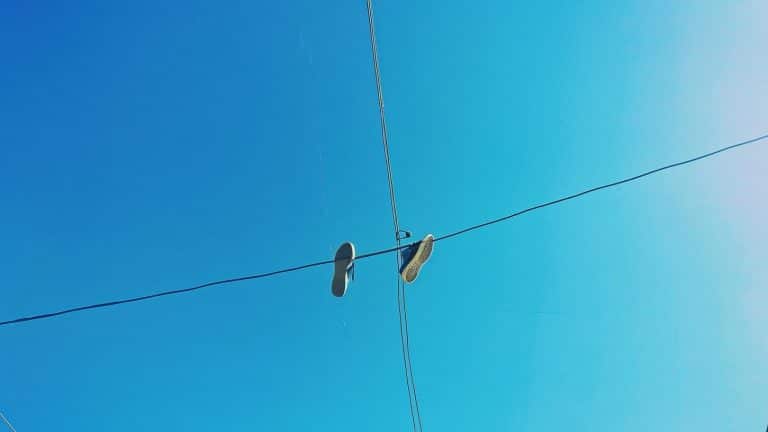 Por que alguns fios de energia têm sapatos pendurados?